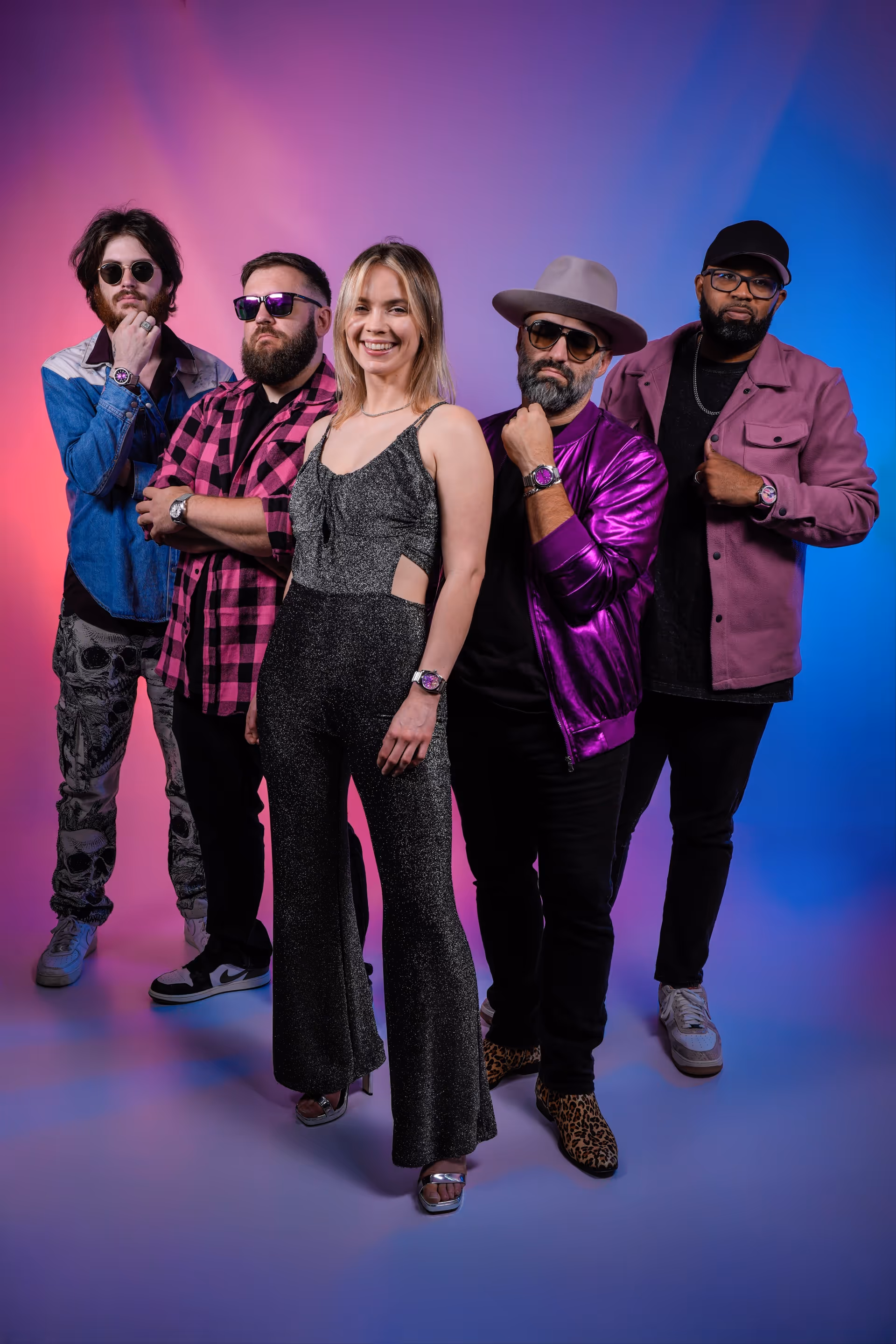 OG Cola full band photo: all five members posed in front of a pink and blue studio backdrop